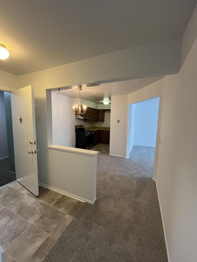 interior space featuring light carpet, baseboards, and a notable chandelier