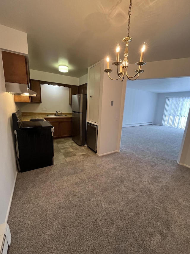 kitchen with freestanding refrigerator, open floor plan, light carpet, and baseboard heating