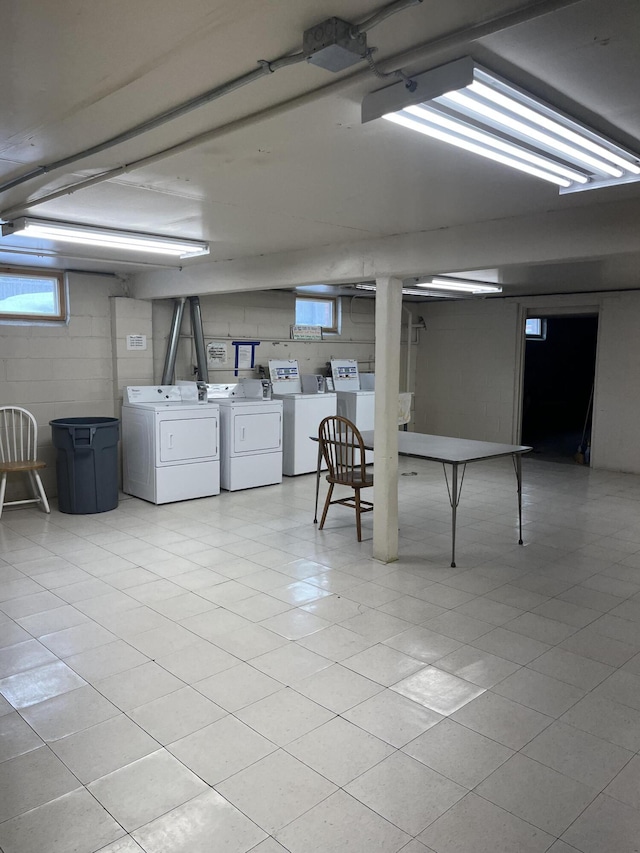 basement with concrete block wall and washer and dryer