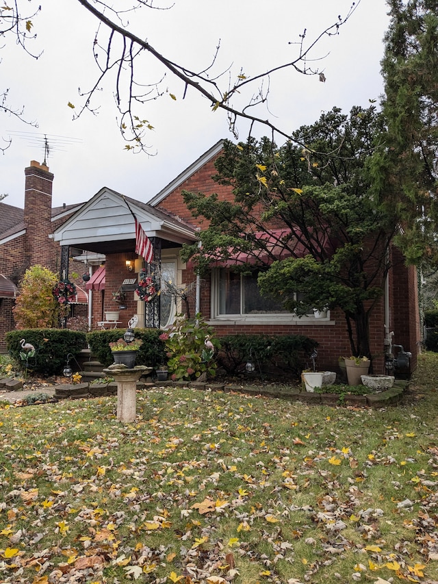 view of front of home with brick siding and a front lawn