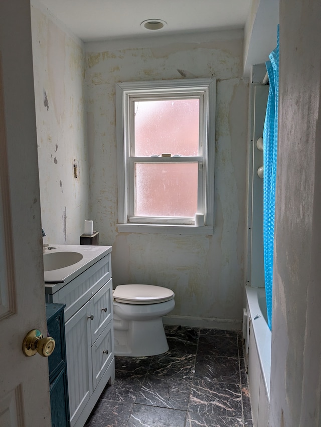 full bathroom featuring marble finish floor, toilet, vanity, a tub, and a shower with curtain