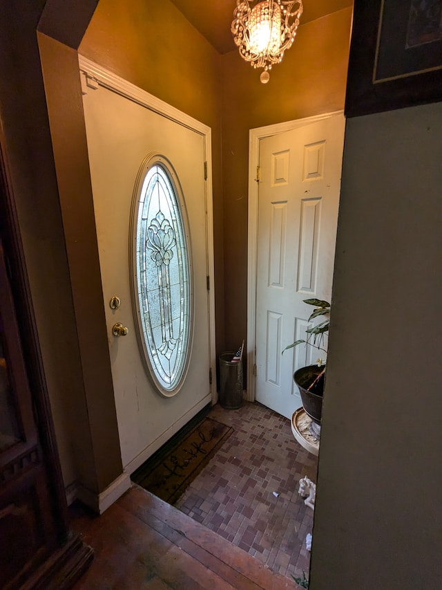 foyer with a chandelier and wood finished floors