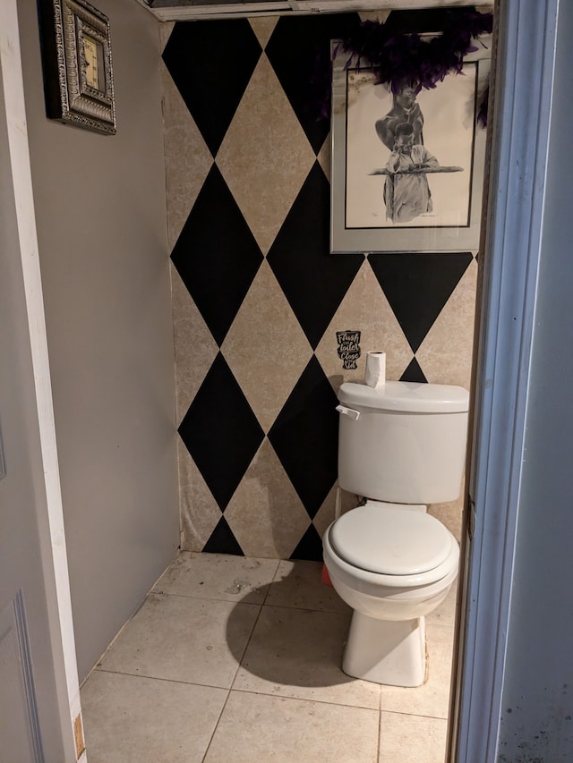 bathroom with toilet and tile patterned floors