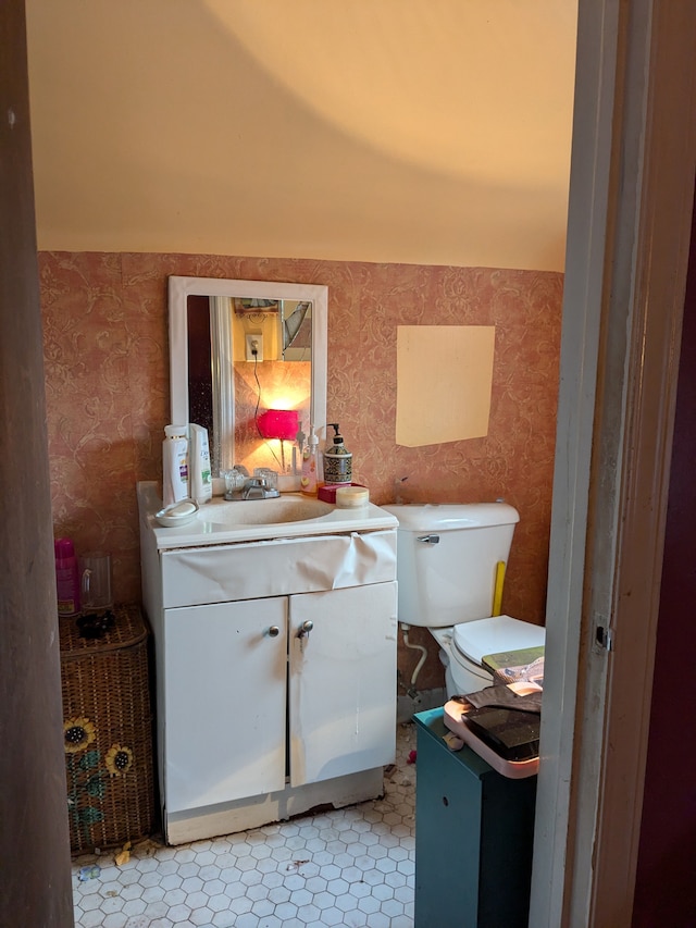 bathroom featuring tile patterned floors, vanity, toilet, and wallpapered walls