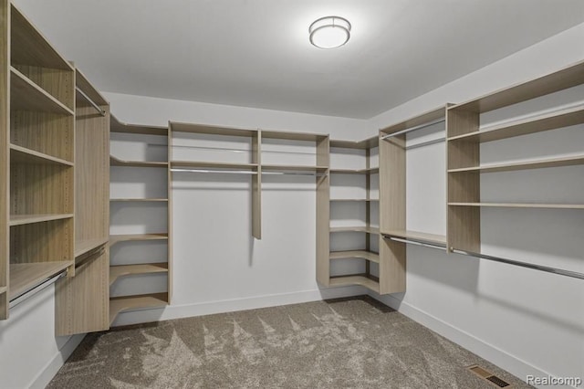 walk in closet with dark colored carpet and visible vents