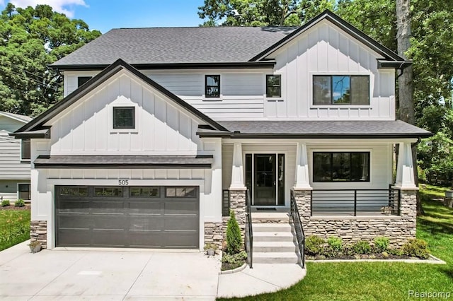 modern inspired farmhouse with covered porch, stone siding, and board and batten siding