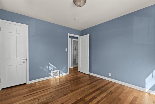 unfurnished bedroom with dark wood-style floors and baseboards