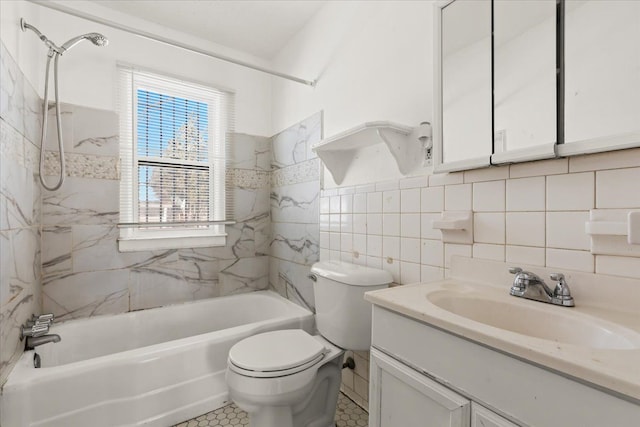 bathroom with tile walls, tub / shower combination, vanity, and toilet