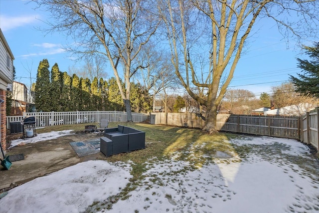 yard covered in snow with a fenced backyard