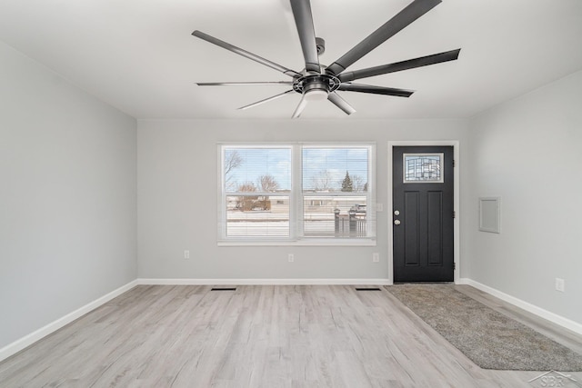 foyer with light wood-style floors, visible vents, and baseboards