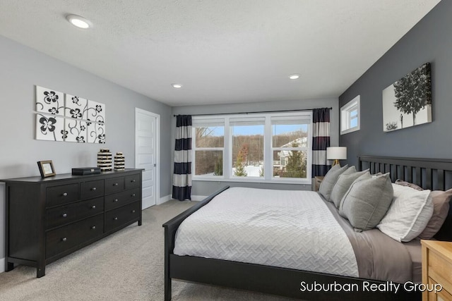 bedroom featuring light carpet, baseboards, a textured ceiling, and recessed lighting