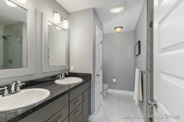 full bathroom featuring marble finish floor, a sink, toilet, and baseboards