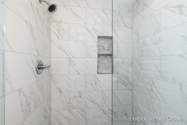 bathroom with tiled shower