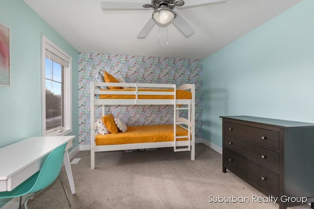 bedroom with wallpapered walls, ceiling fan, baseboards, and light colored carpet