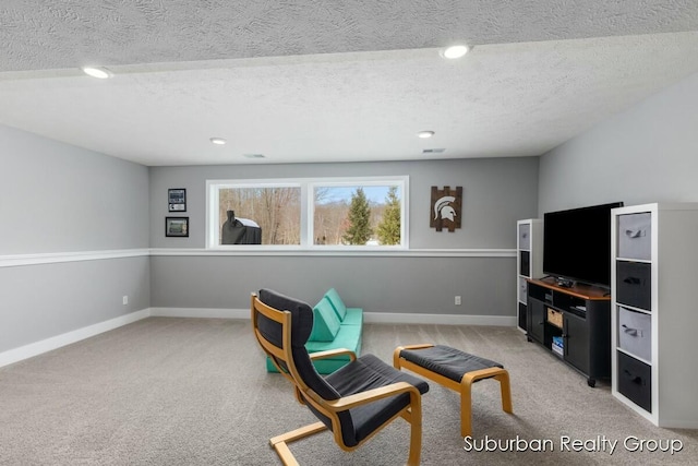 sitting room with a textured ceiling, recessed lighting, light carpet, visible vents, and baseboards