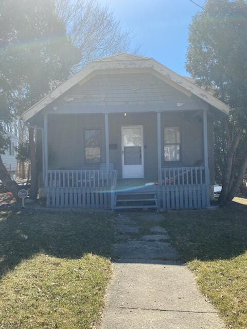 bungalow with a porch and a front yard