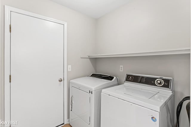 washroom featuring laundry area and separate washer and dryer