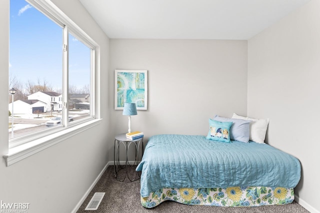 bedroom featuring carpet floors, visible vents, and baseboards