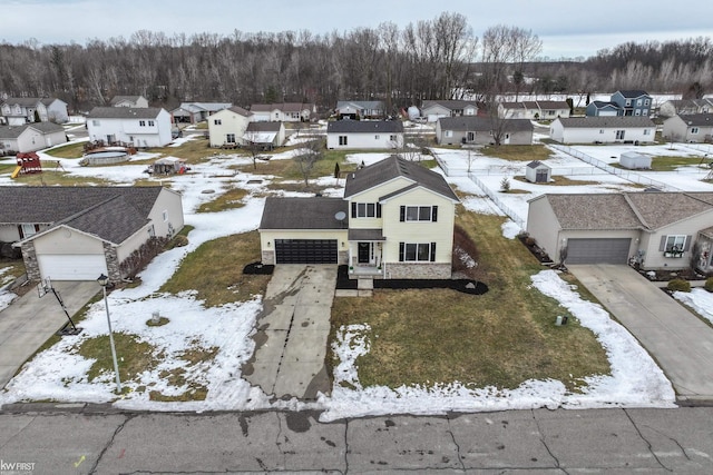 snowy aerial view with a residential view