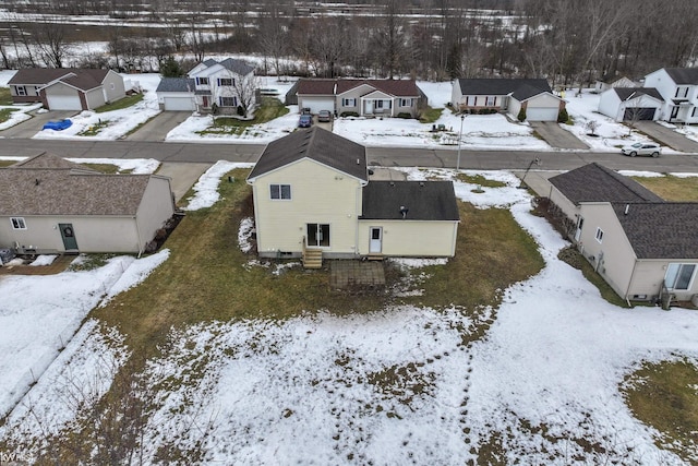 snowy aerial view featuring a residential view