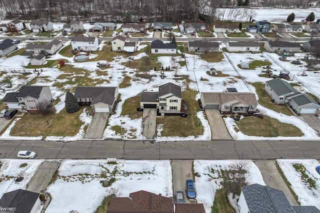 snowy aerial view featuring a residential view