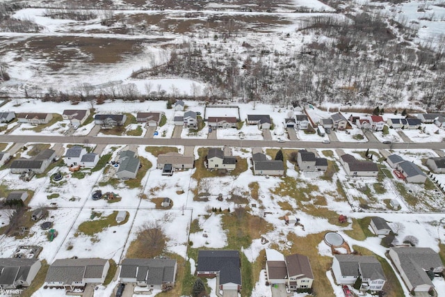 snowy aerial view with a residential view