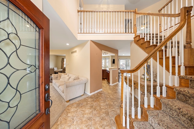 foyer featuring stairs, recessed lighting, visible vents, and baseboards