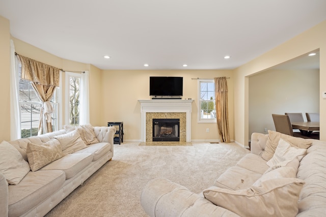 living room featuring light carpet, baseboards, and recessed lighting