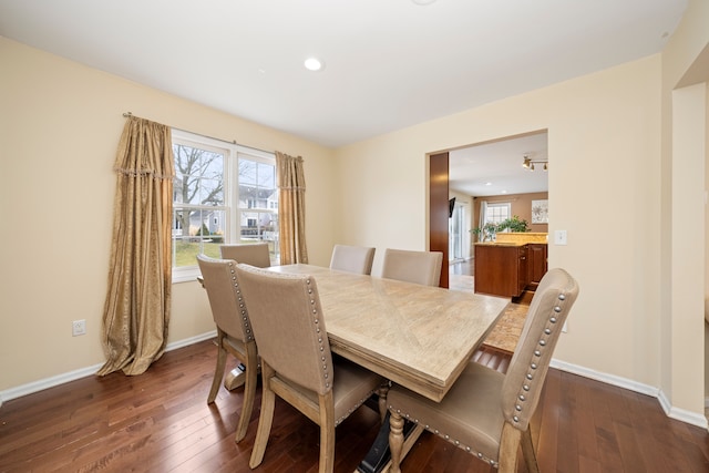 dining room with dark wood-style floors, recessed lighting, and baseboards