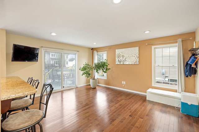 dining space featuring recessed lighting, hardwood / wood-style flooring, and baseboards