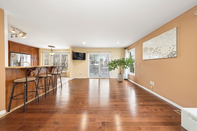 living room featuring recessed lighting, dark wood-style flooring, and baseboards