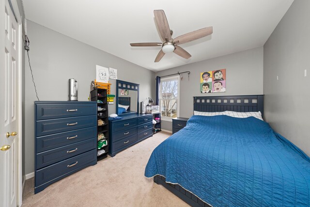 bedroom featuring light carpet, ceiling fan, and baseboards