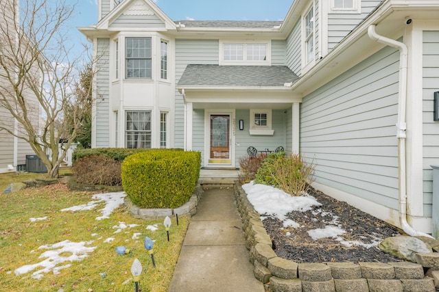 doorway to property featuring a shingled roof