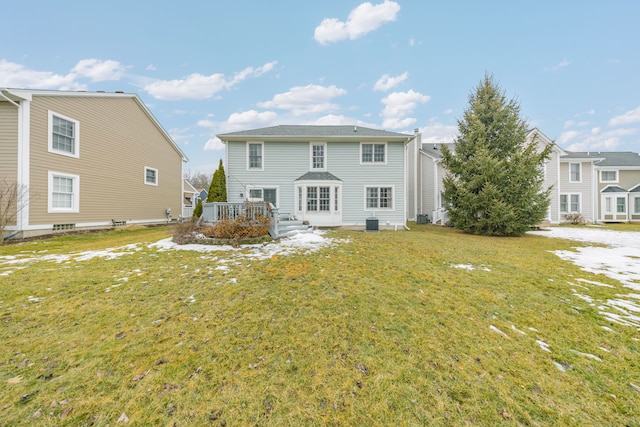 back of house with a deck and a lawn