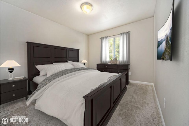 bedroom featuring baseboards and light colored carpet