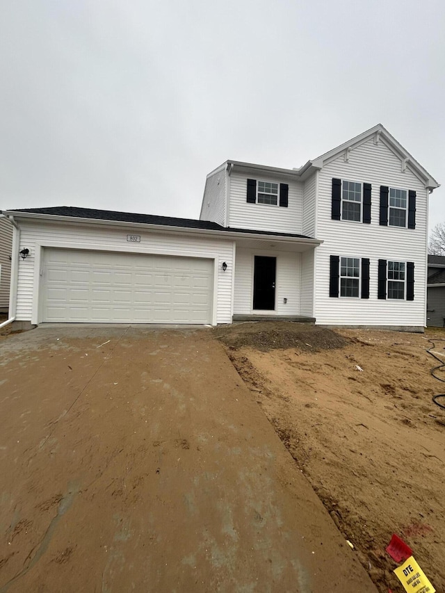 traditional home featuring driveway and an attached garage