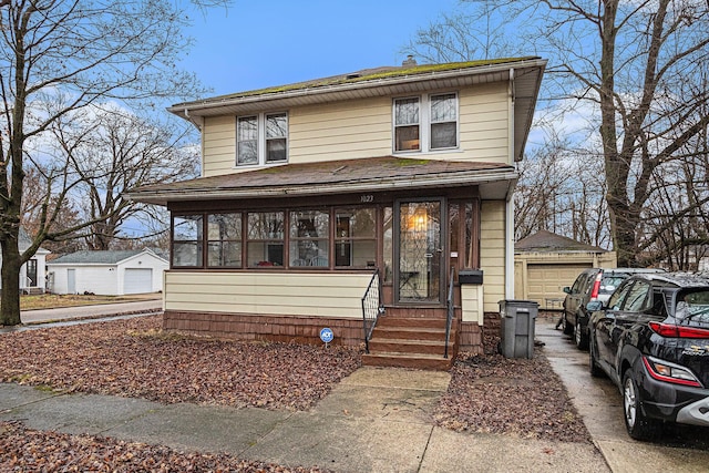 traditional style home with an outbuilding, a sunroom, a garage, and entry steps