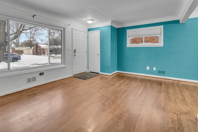 entryway with visible vents, baseboards, and wood finished floors