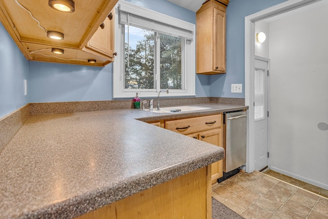 kitchen featuring a sink, dark countertops, light brown cabinets, and dishwasher