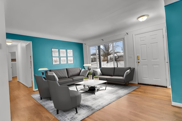 living room featuring baseboards and light wood finished floors