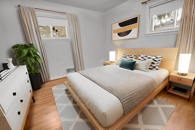 bedroom featuring visible vents and light wood-style floors