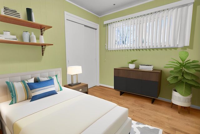 bedroom with a closet, light wood-type flooring, and crown molding