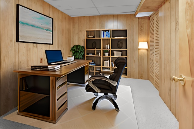 office featuring wood walls and a paneled ceiling