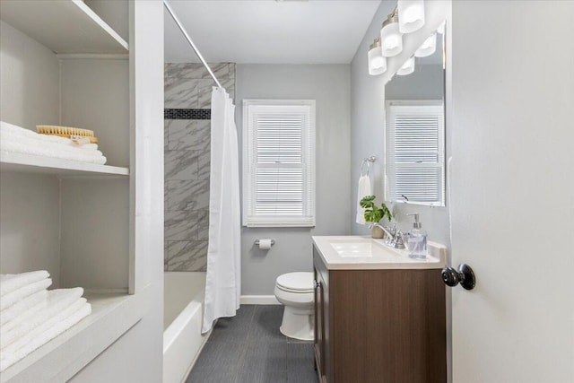 bathroom featuring toilet, baseboards, shower / tub combo with curtain, and vanity