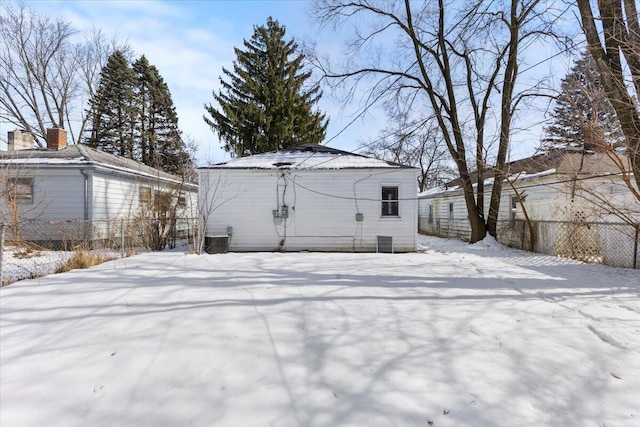 snow covered property with fence