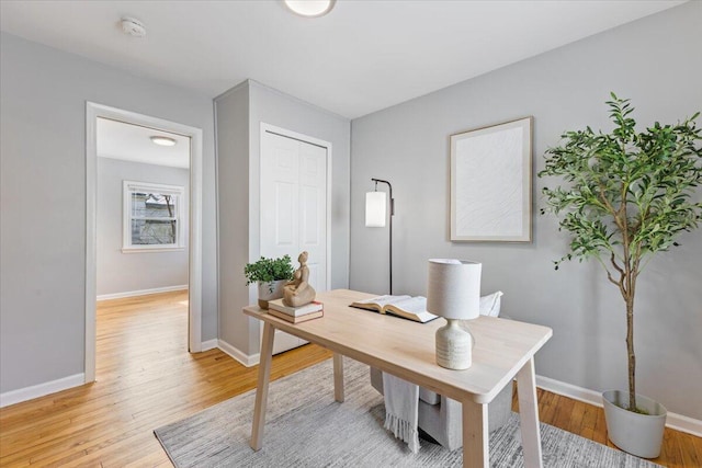 office featuring light wood-style flooring and baseboards