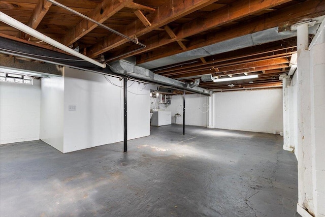 unfinished basement with washing machine and clothes dryer