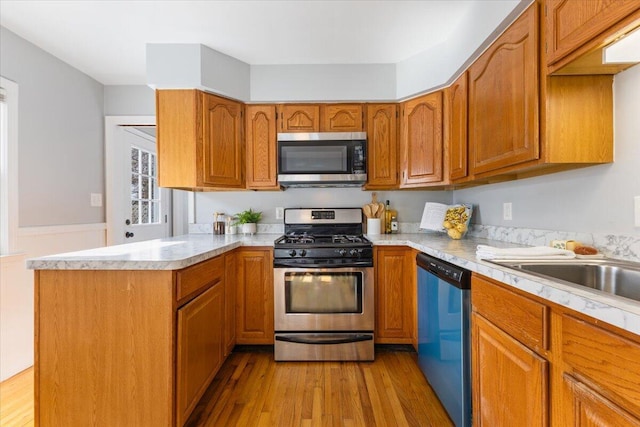 kitchen featuring light countertops, appliances with stainless steel finishes, and light wood-style floors