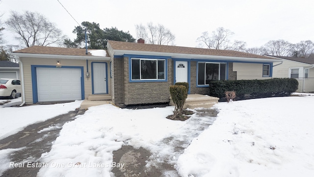 single story home featuring a garage and a chimney