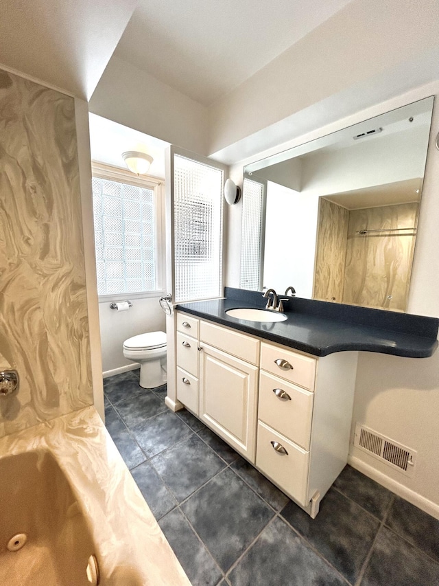 bathroom with baseboards, visible vents, toilet, a combined bath / shower with jetted tub, and vanity